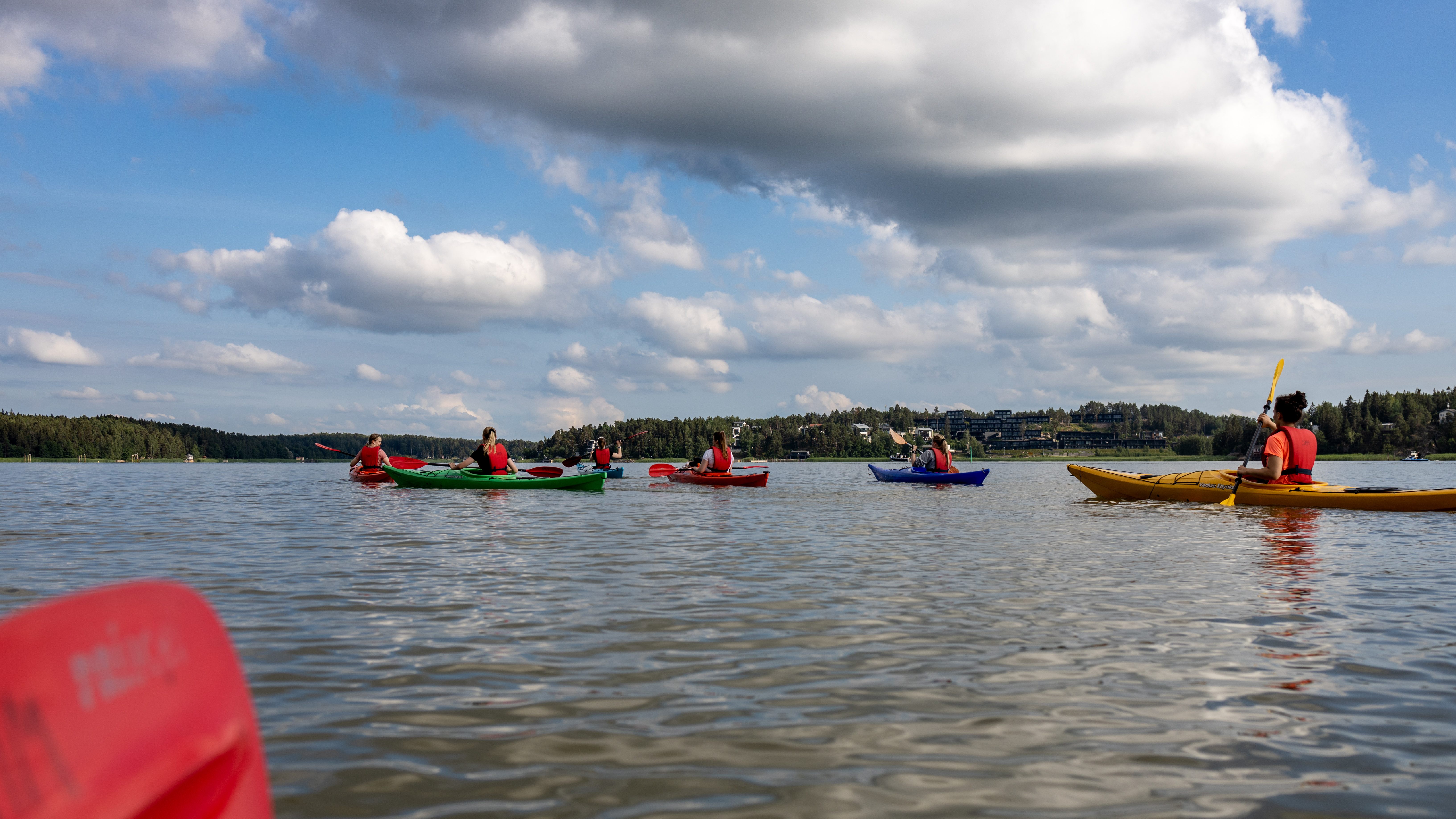 The picture of Aboa’s team members kayaking.